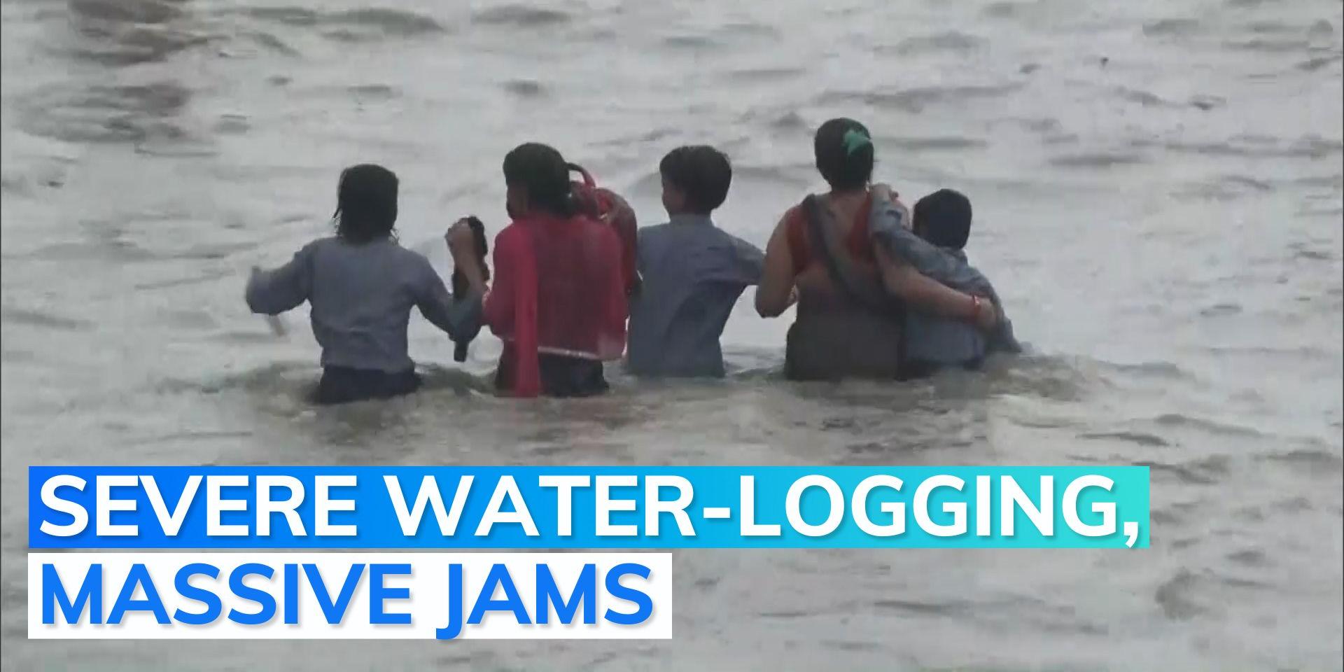 People wade through waisthigh water as heavy rains lash Delhi NCR